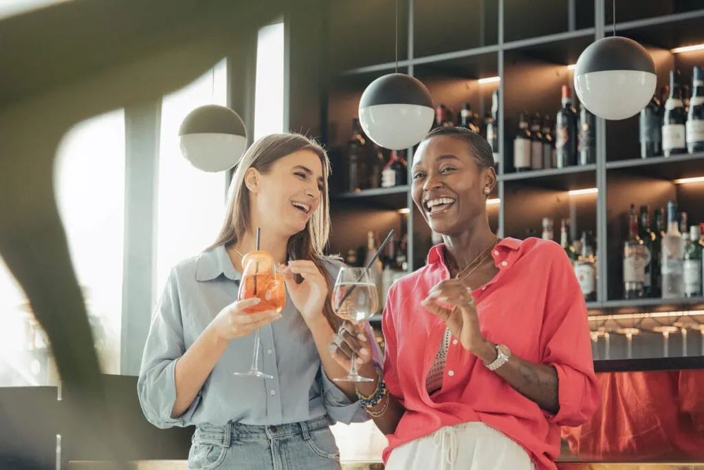 Tourists having a laugh together whilst enjoying a drink at the Verdi bar