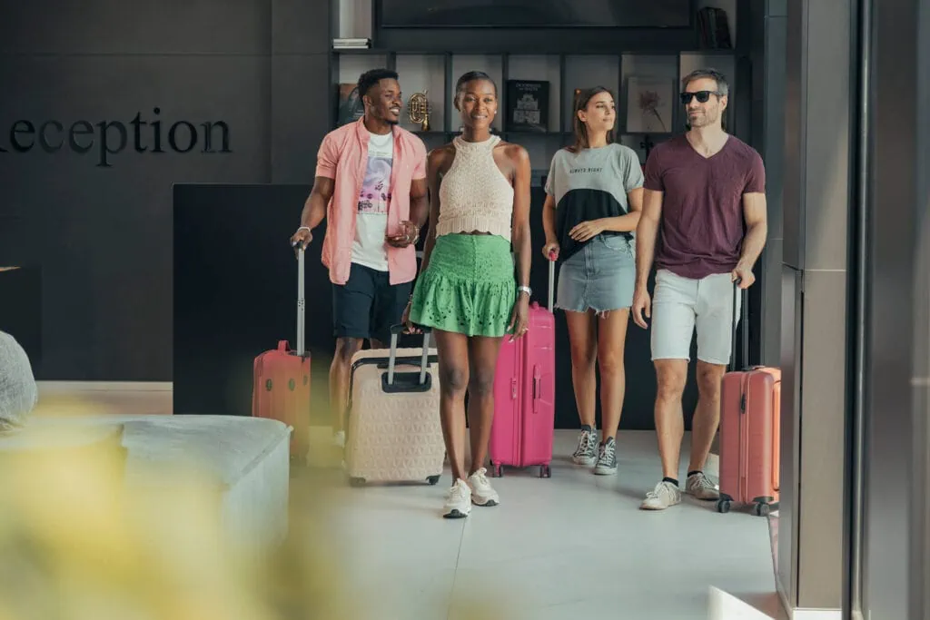 Group of guests arriving at a Verdi Hotel about to check in