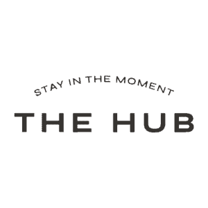 Text logo with "Stay in the Moment" above "The Hub" in bold capital letters on a white background.