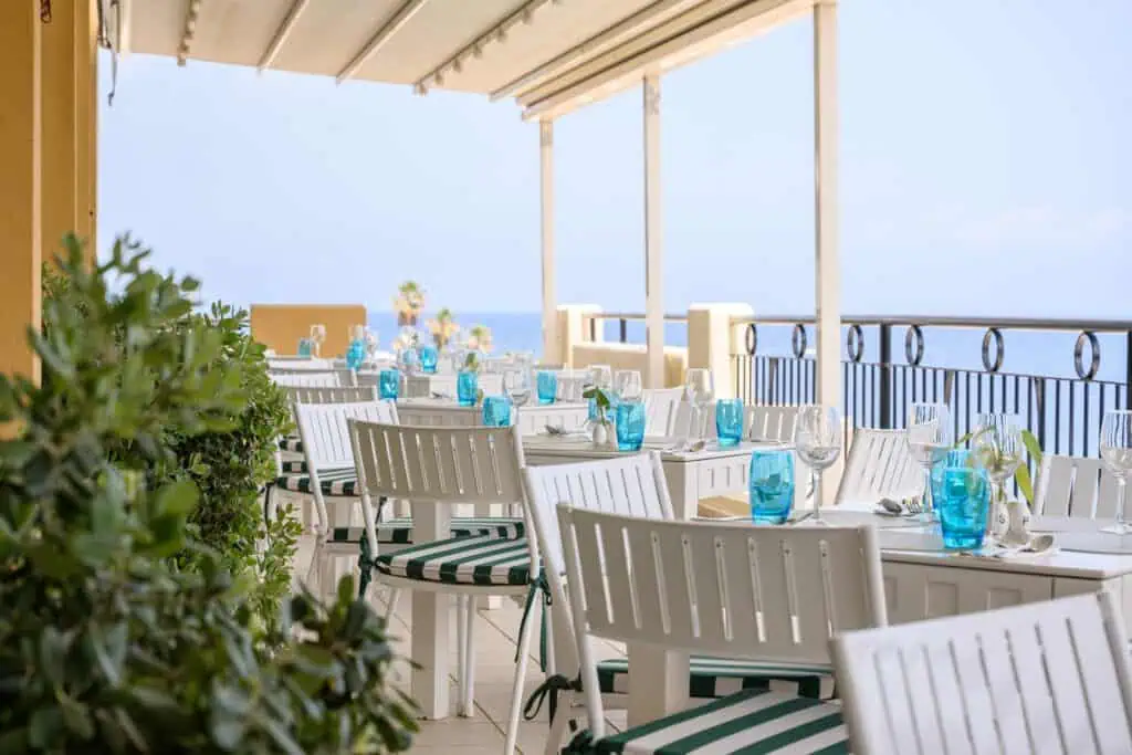 Outdoor restaurant table setting near the coastline